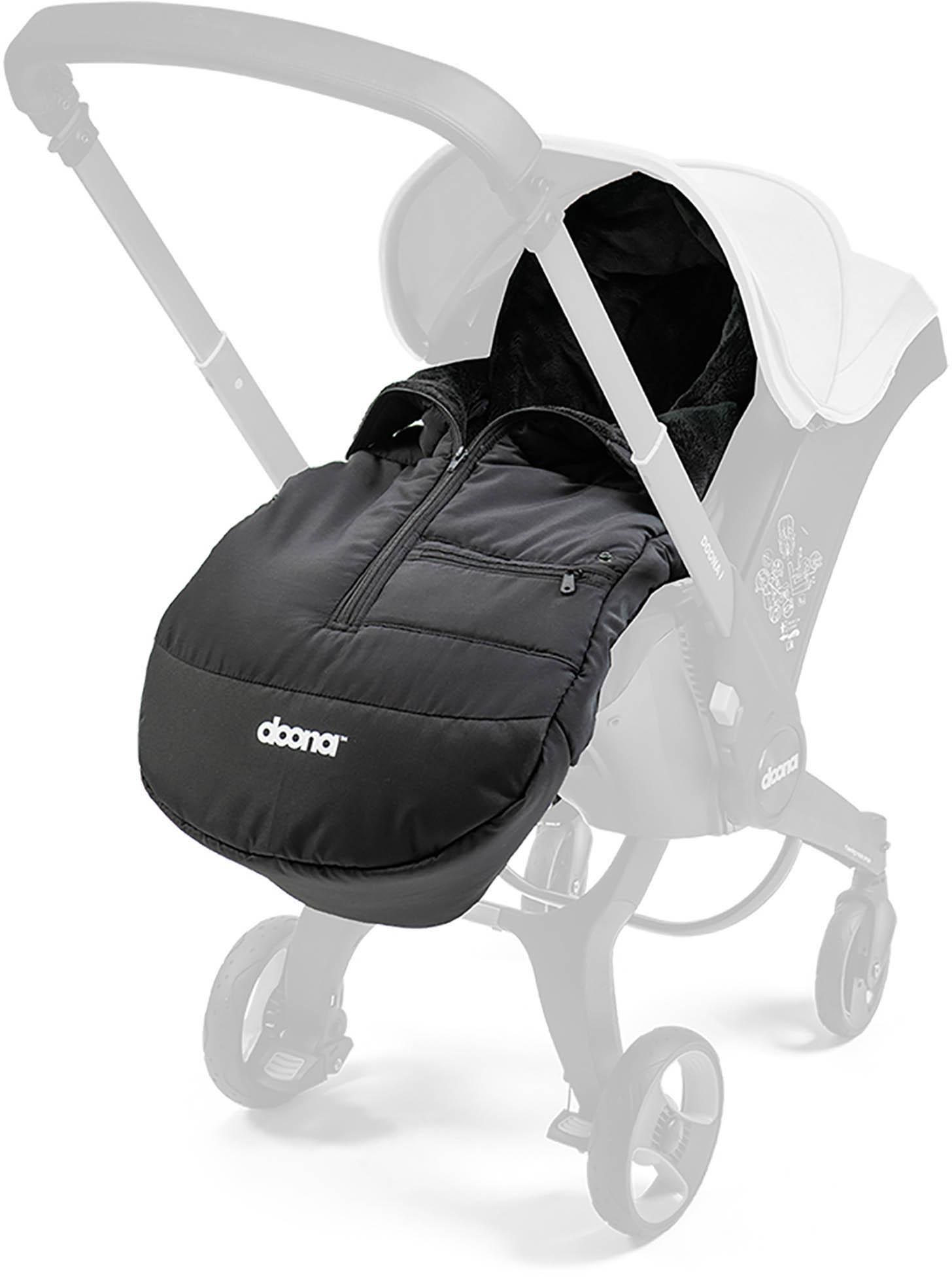 Black Doona Winter Footmuff with zip closure, fleece lining, attached to a stroller, featuring a sleek, padded design.
