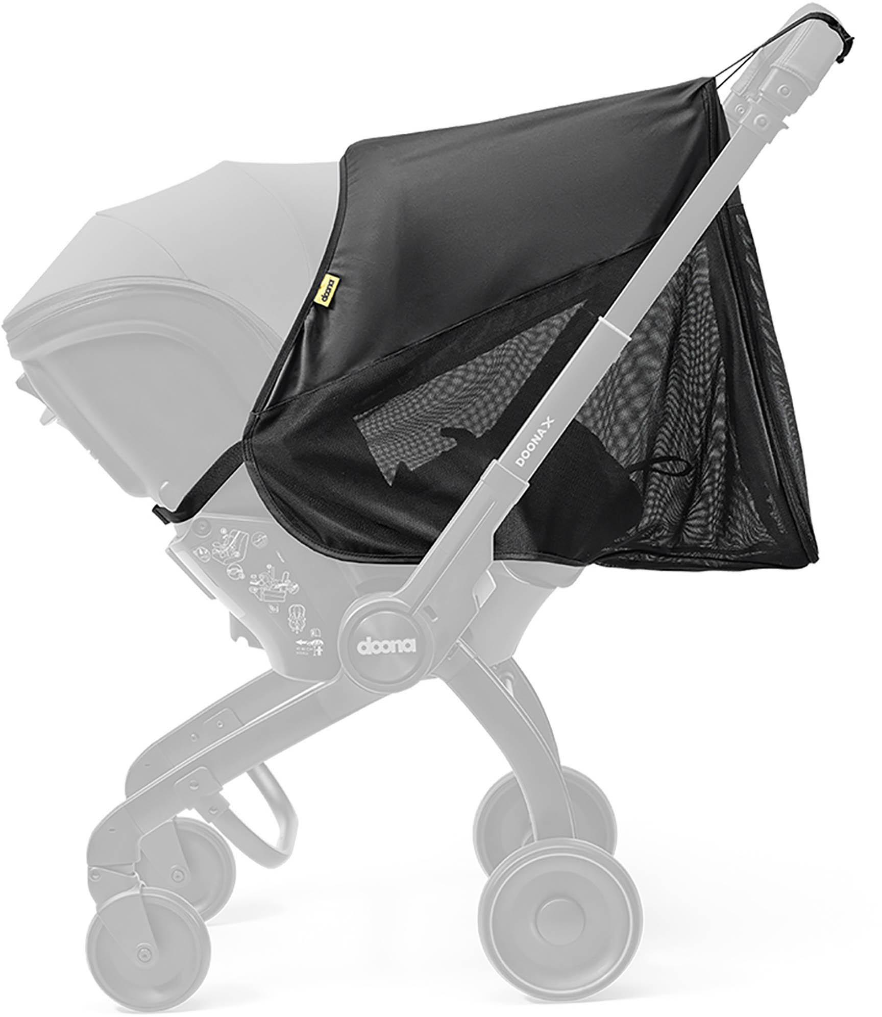 Black mesh Doona X 360° Protection cover on gray stroller frame, featuring a sleek design and yellow logo tag.