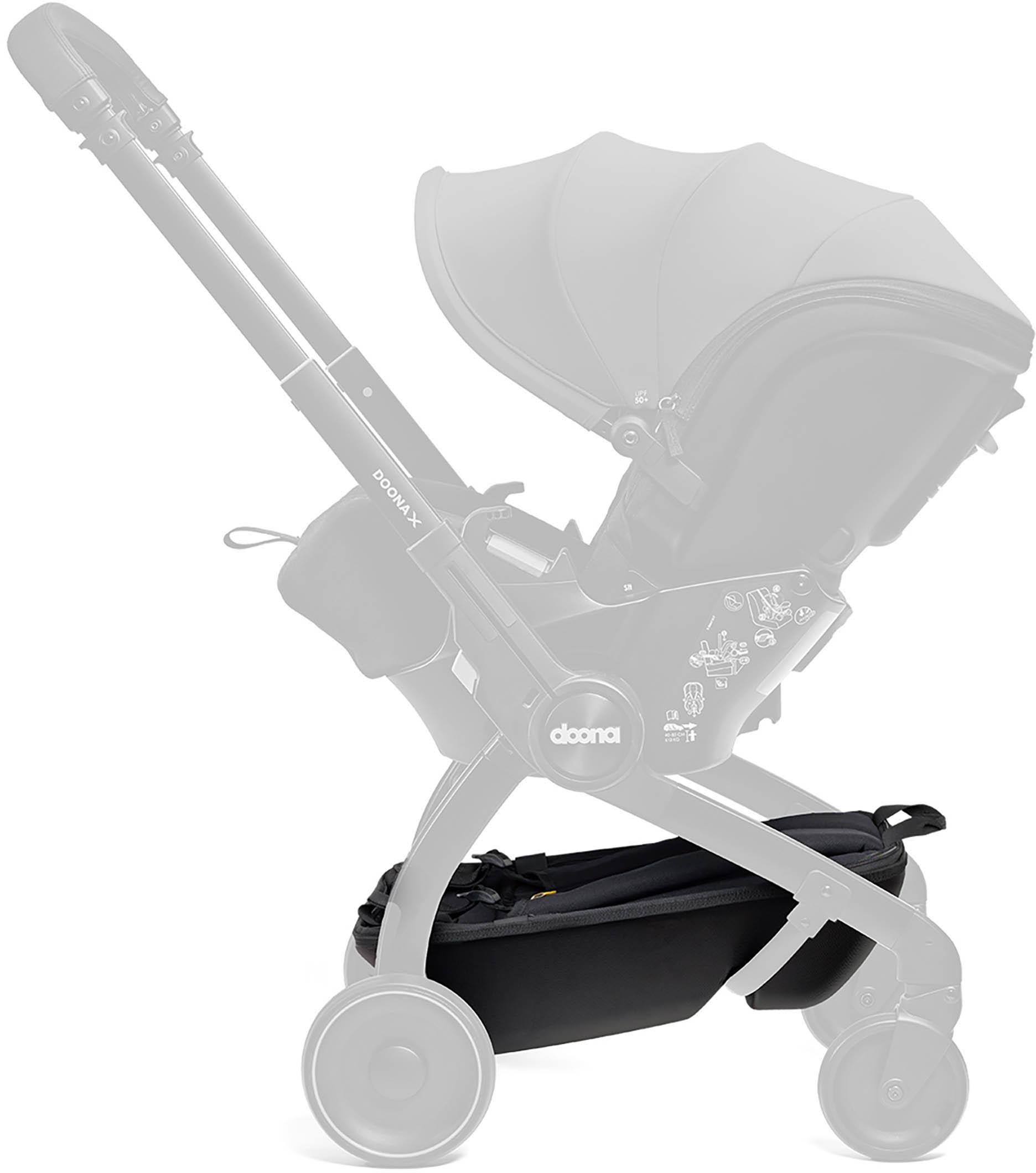 Black Doona X Pack & Go Basket attached to stroller frame, featuring a sleek design and spacious storage compartment.