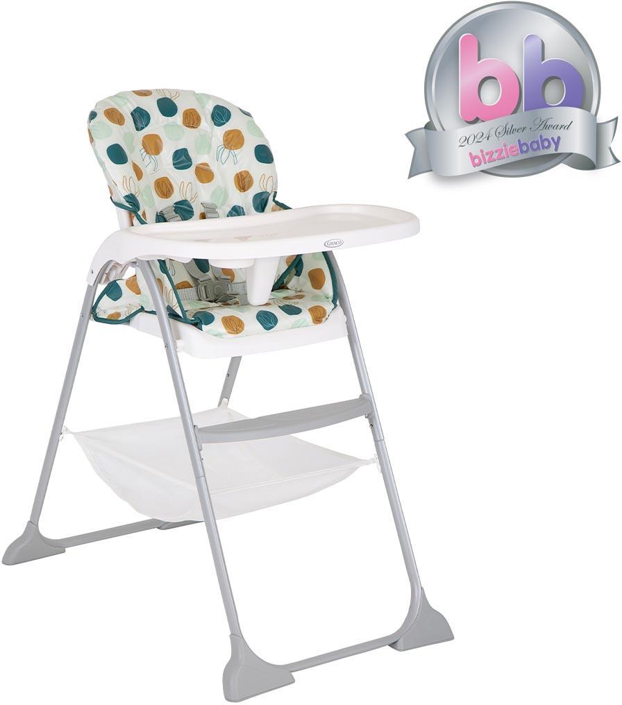Graco SnackEase Highchair in Organza pattern with colorful circles, white tray, and gray metal legs.