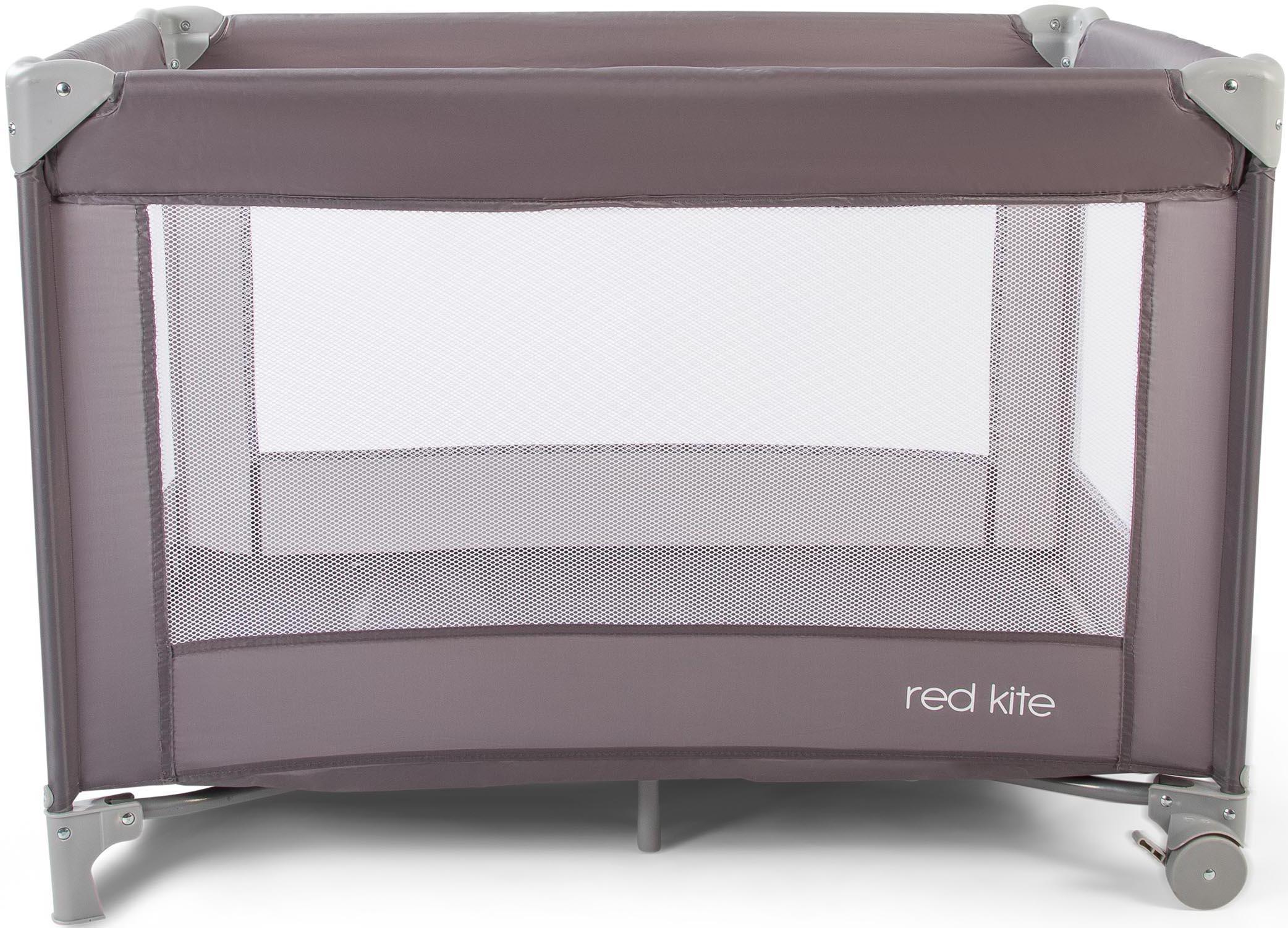 Gray Red Kite Sleeptight travel cot with mesh sides and sturdy frame, featuring the "red kite" logo on the base.