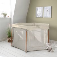 Hexagonal ecru playpen with mesh sides, wooden frame, and soft fabric top, in a cozy room with toys and decor.