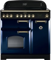 Classic Deluxe 90cm induction range cooker in regal blue with brass trim, featuring a sleek design, multiple control knobs, and two ovens with a glass window.