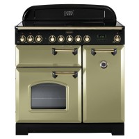 Classic Deluxe 90cm induction range cooker in olive green with brass trim, featuring multiple control knobs, a glass oven door, and a sleek black hob surface.