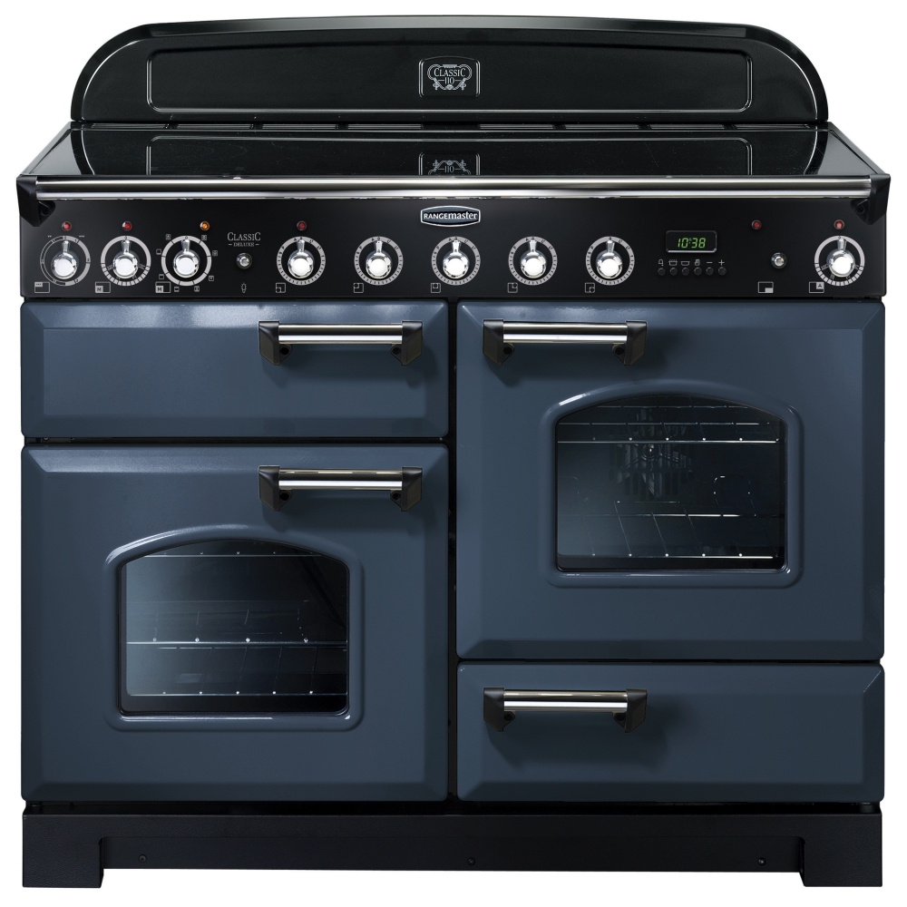 CCLASSIC Deluxe 110cm induction range cooker in stone blue with chrome trim, featuring multiple knobs, two glass-fronted ovens, and a sleek black top.