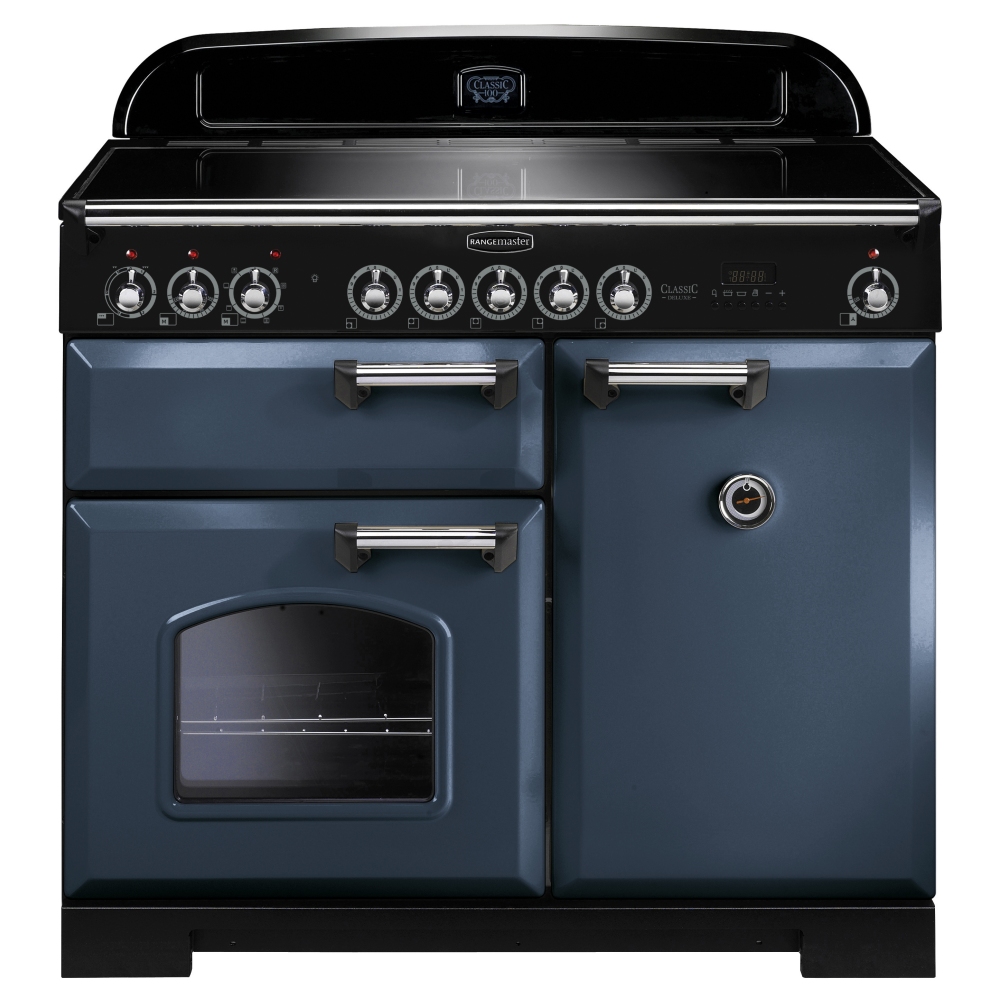 Classic Deluxe 100cm induction range cooker in stone blue with chrome trim, featuring six control knobs, two ovens, and a sleek black top.