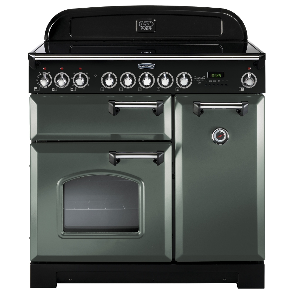 Classic Deluxe 90cm induction range cooker in mineral green with chrome trim, featuring six control knobs, a large oven window, and a sleek black top surface.