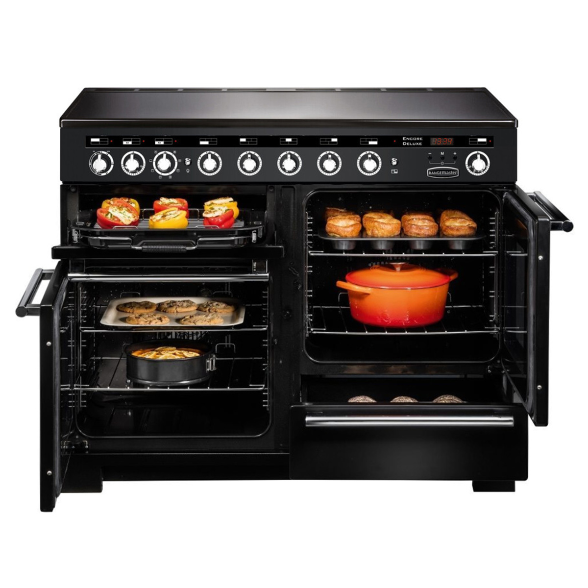 Deluxe 110cm induction range cooker in charcoal black with chrome trim, featuring multiple burners, two ovens, and a bright red casserole dish inside.