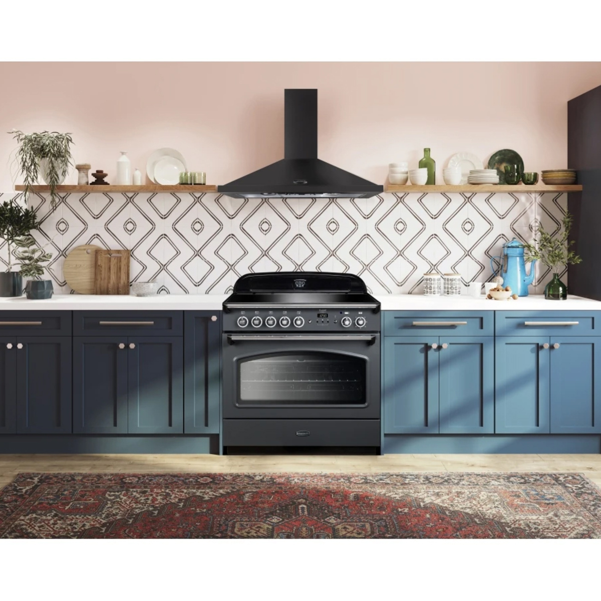 Classic FX 90cm induction fuel range cooker in black with chrome trim, featuring five knobs, a large oven window, and a sleek design, set against a stylish kitchen backdrop.