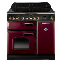 Classic 90cm induction range cooker in cranberry with brass trim, featuring a sleek black glass top, multiple control knobs, and a spacious oven with a viewing window.
