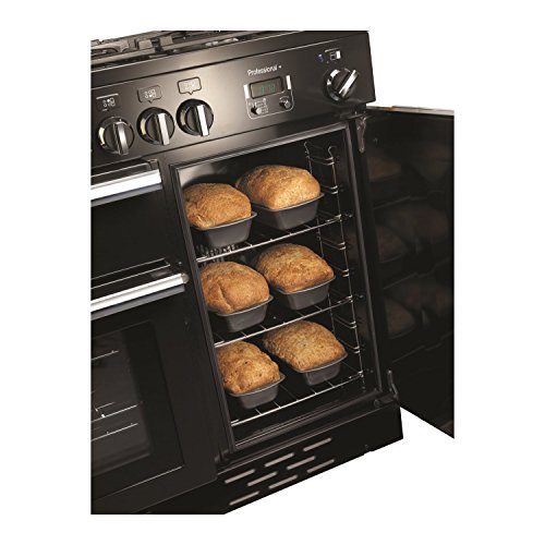 Stainless steel Rangemaster PROP100EISSC Professional Plus 100cm electric induction range cooker with multiple knobs, digital display, and an oven filled with loaf pans.