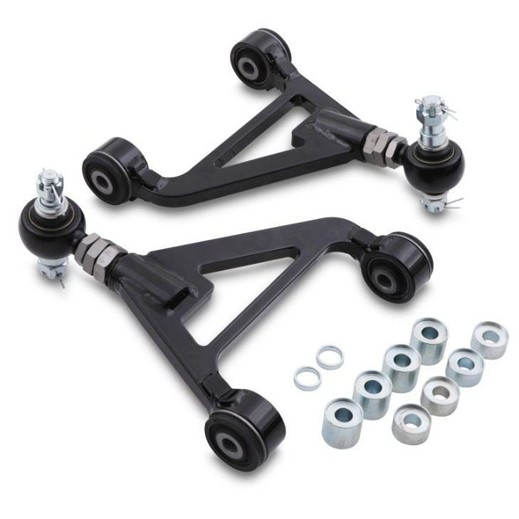 Black adjustable rear upper camber arms with rubber bushings and ball joints, accompanied by metal washers, designed for Honda S2000 AP1/AP2 models from 1999 to 2009.