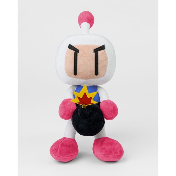 White plush Bomberman character with a pink bomb, blue vest, and pink feet, featuring black eyes and a red pom-pom on top of its head.