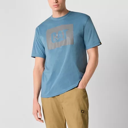 Blue cotton men's t-shirt featuring a large gray Caterpillar logo on the front, paired with khaki pants, showcasing a casual style.