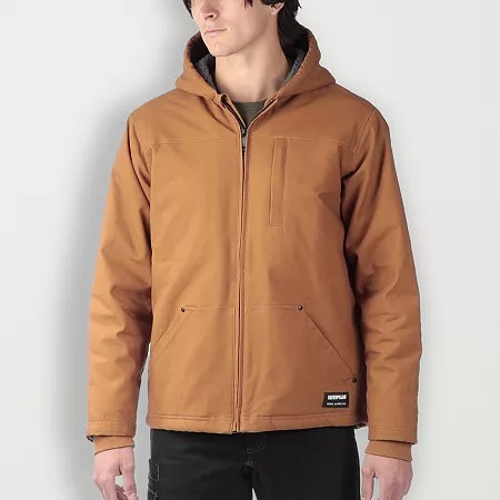 Bronze fleece jacket with a hood, featuring a Sherpa lining, front pockets, and a zip closure, worn by a model against a neutral background.