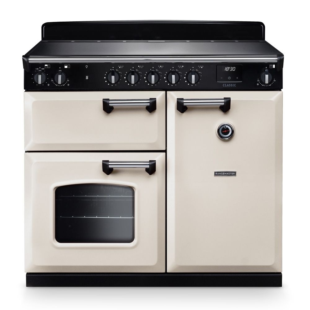Classic 100cm induction cooker in pale cream and chrome, featuring a black control panel with six knobs, two ovens, and a sleek design.