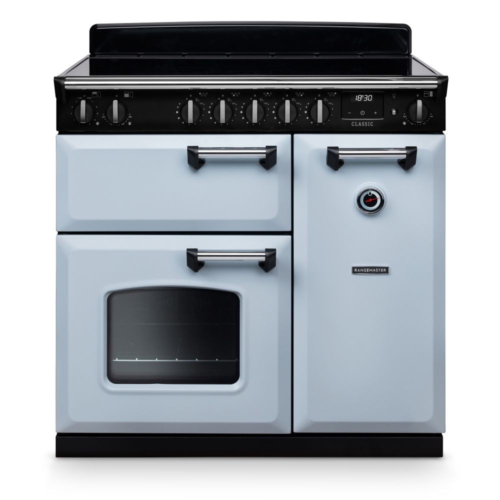 Classic 90cm induction cooker in misty blue with chrome accents, featuring a black glass top, six control knobs, and two ovens with a sleek design.
