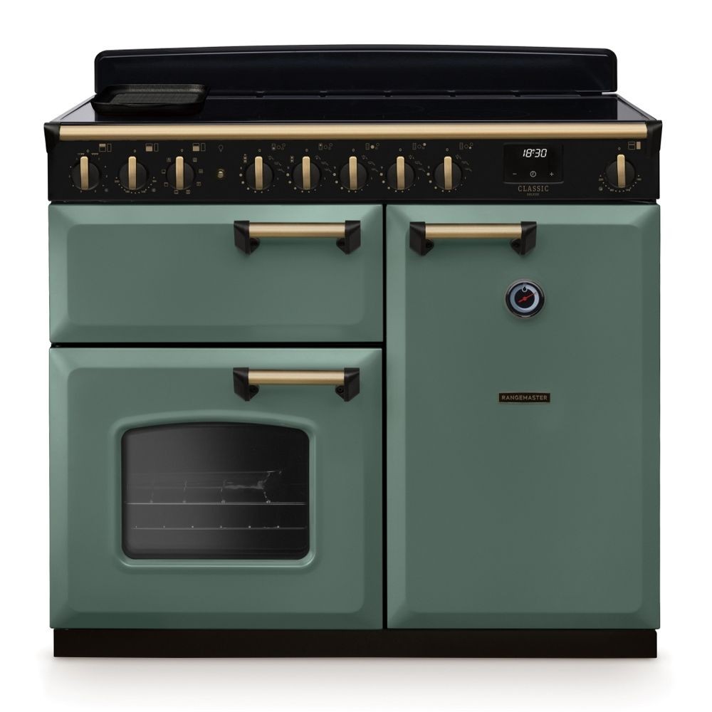 Classic Deluxe 100cm induction range cooker in mineral green with antique brass accents, featuring a sleek black hob, multiple control knobs, and a large oven window.