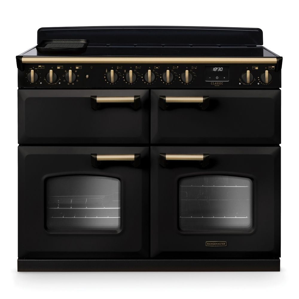 Classic Deluxe 110cm BC range cooker in charcoal black with antique brass accents, featuring four ovens, a ceramic hob, and control knobs for precise cooking.