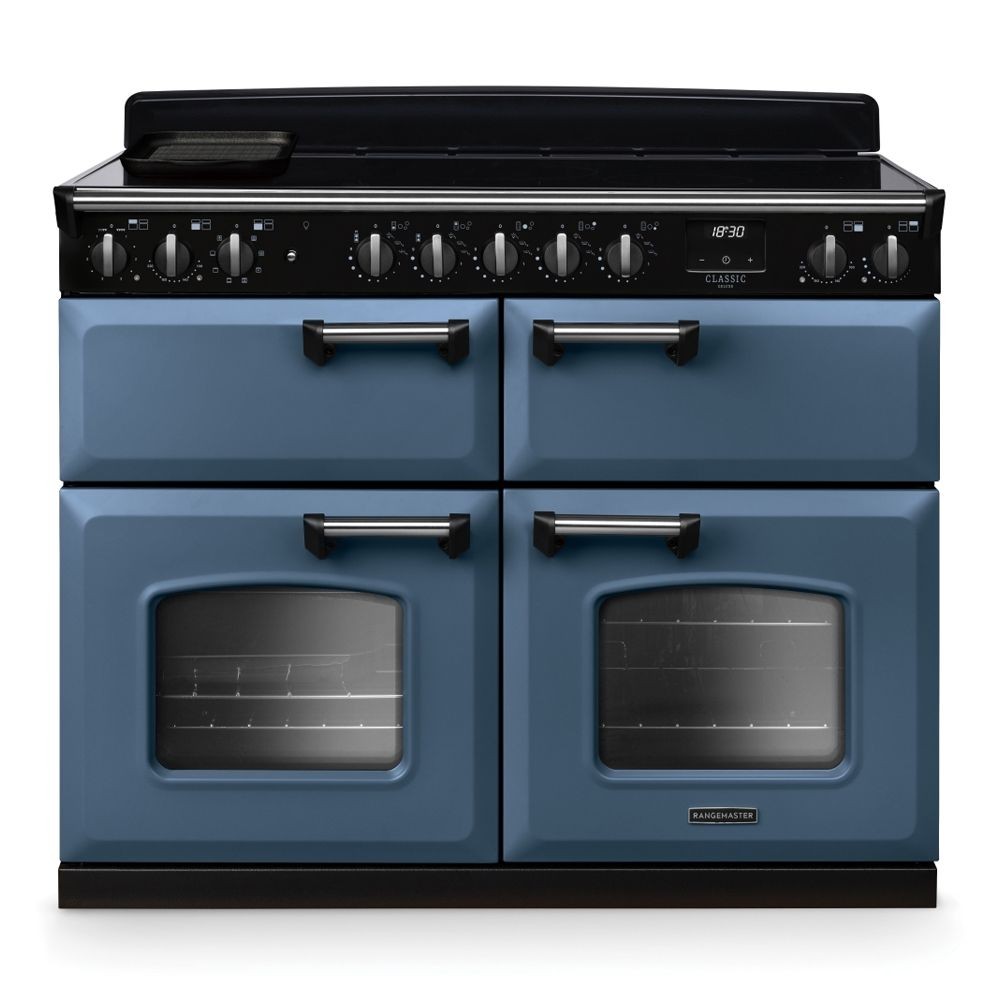 Classic Deluxe 110cm BC induction range cooker in stone blue with chrome accents, featuring four hobs, two ovens, and sleek control knobs on a black panel.