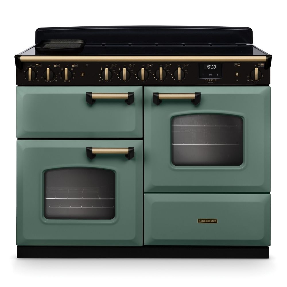 Classic Deluxe 110cm induction range cooker in mineral green with antique brass accents, featuring two ovens, six control knobs, and a sleek black hob.
