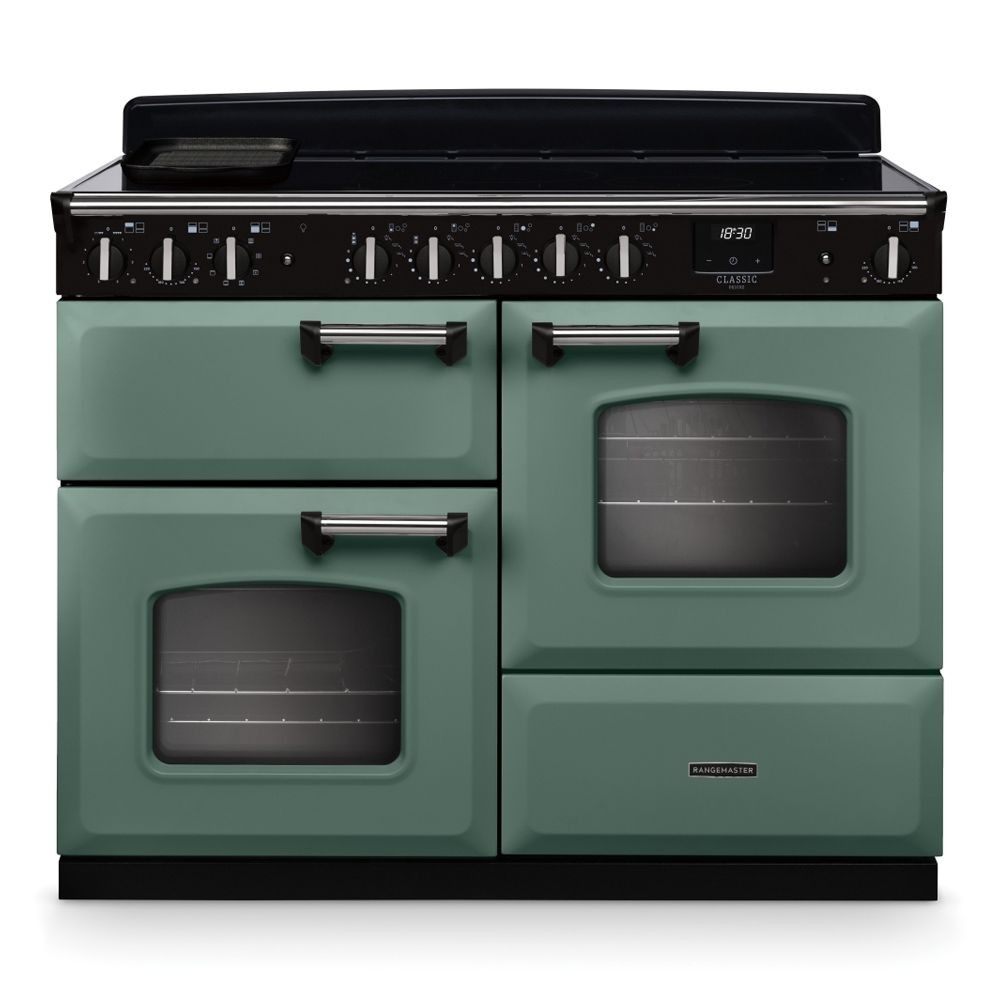 Classic Deluxe 110cm OC induction range cooker in mineral green with chrome accents, featuring two ovens, a sleek black control panel, and multiple knobs for precise temperature control.