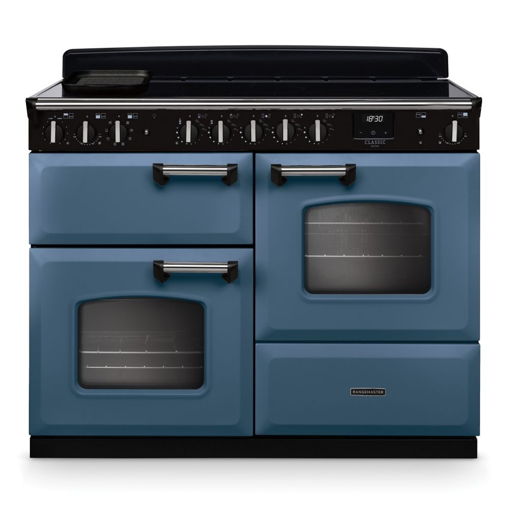 Classic Deluxe 110cm induction range cooker in stone blue with chrome accents, featuring four burners, two ovens, and a sleek black control panel with knobs.