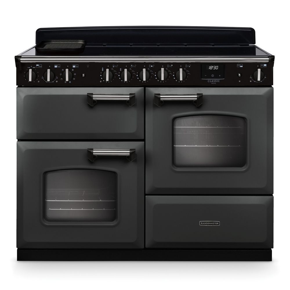 Classic Deluxe 11cm OC induction range cooker in slate and chrome, featuring a sleek black control panel, multiple knobs, two ovens, and a smooth induction hob.