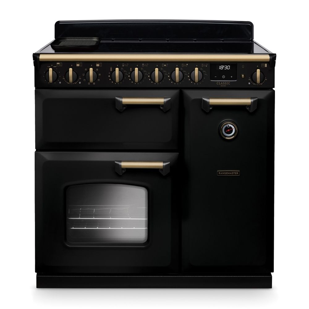 Classic Deluxe 90cm induction cooker in black and chrome, featuring a sleek design, brass knobs, a large oven door, and a smooth induction cooktop.
