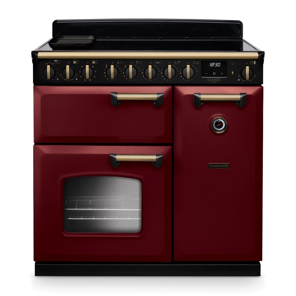 Classic Deluxe 90cm induction range cooker in Bordeaux red with antique brass accents, featuring five knobs, a black glass top, and two ovens.