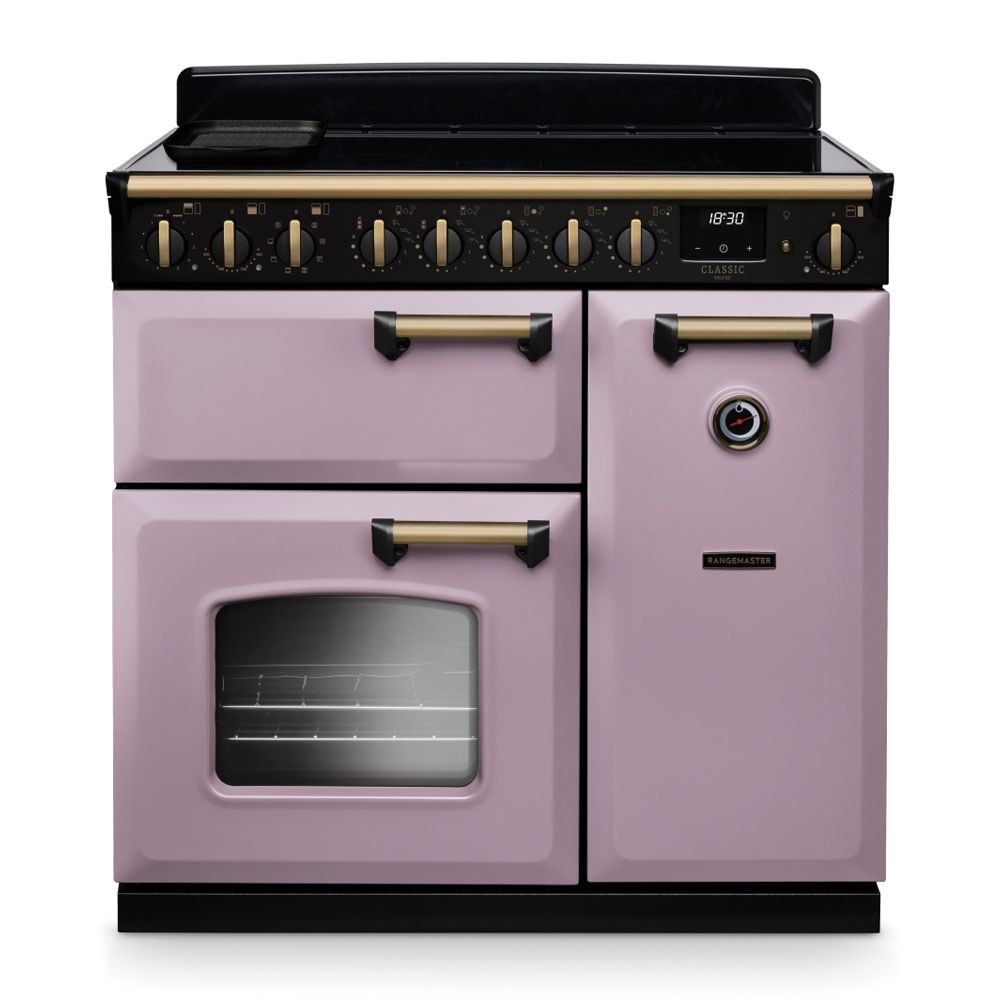Classic Deluxe 90cm induction range cooker in heather color with antique brass knobs, featuring two ovens, a grill, and a sleek black top surface.