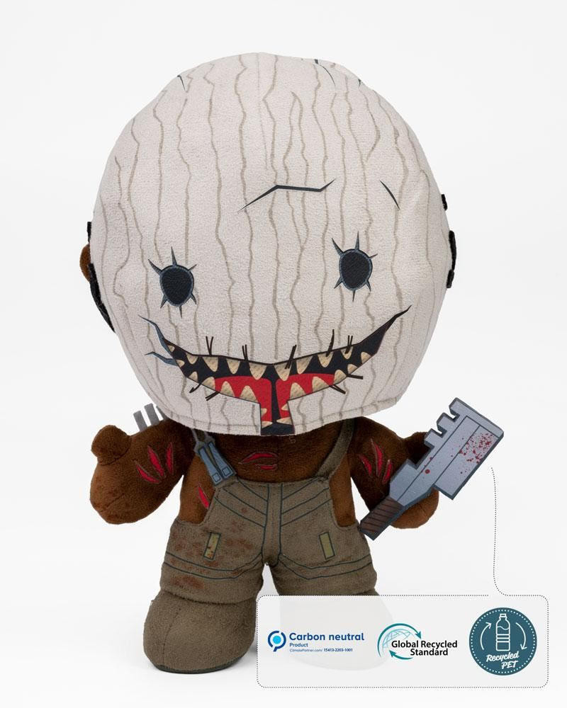 Plush figure of the Trapper from Dead by Daylight, featuring a textured, light brown mask with a sinister smile, brown arms, and holding a metallic weapon, dressed in dark overalls.