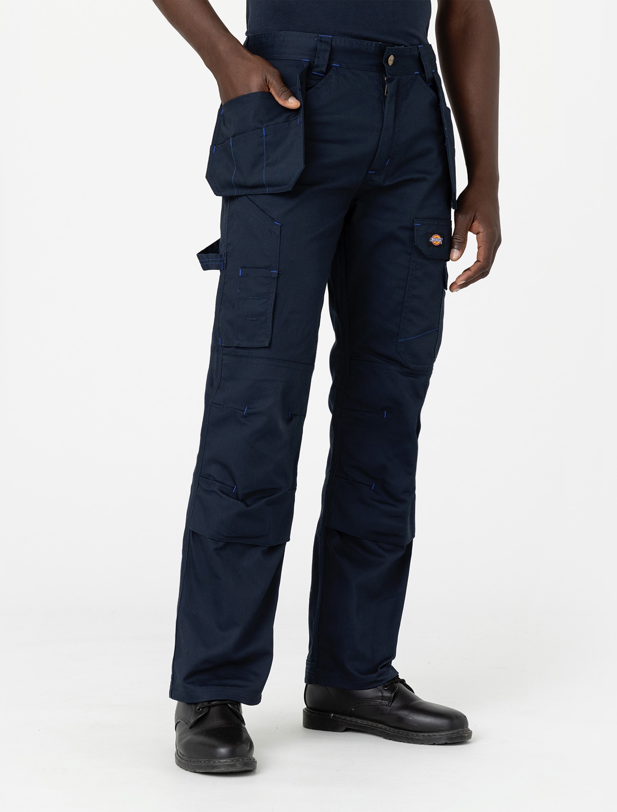 Blue polyester outdoor trousers featuring multiple pockets, reinforced knees, and contrasting stitching, designed for durability and comfort in outdoor activities.