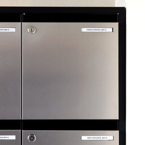 Silver metal mailbox with a black frame, featuring two labeled name tags in white text, secured with a keyhole for locking.