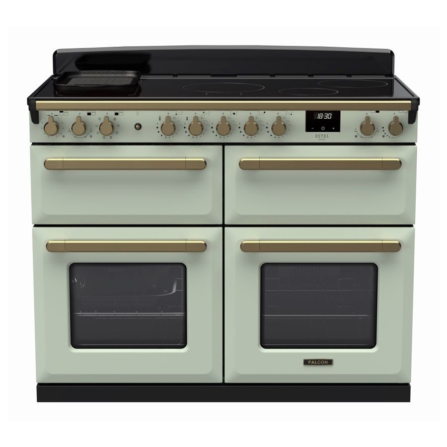 Mint green induction range cooker with antique brass accents, featuring four knobs, two ovens with glass doors, and a sleek black cooktop.