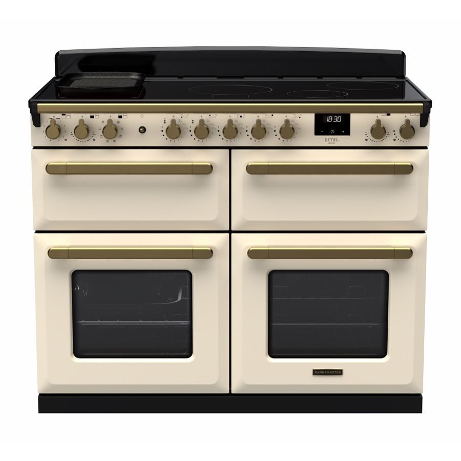 Pale cream induction range cooker with antique brass accents, featuring four oven doors, control knobs, a digital display, and a sleek black cooktop.