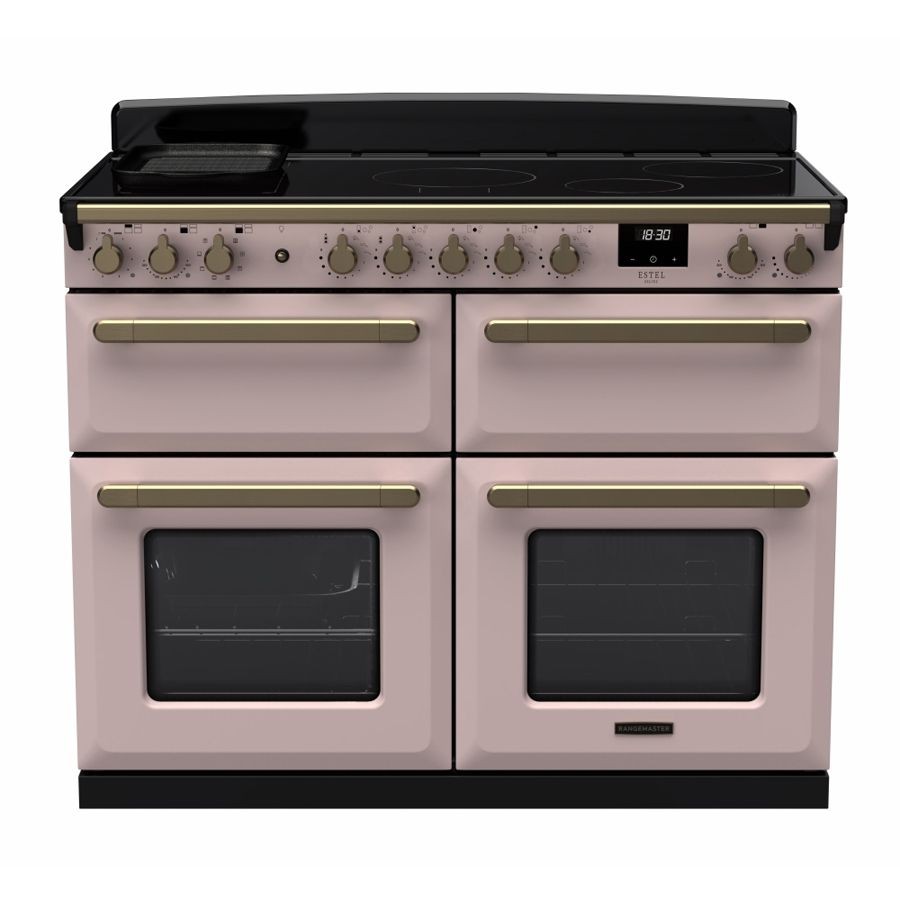Rangemaster Estel Deluxe 110cm BC induction range cooker in pale pink with antique brass handles, featuring four ovens and a sleek black top with control knobs.