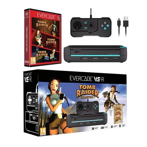 Black gaming console with blue accents, a controller, USB cable, and a Tomb Raider game case featuring Lara Croft on the cover, all displayed in a colorful box.