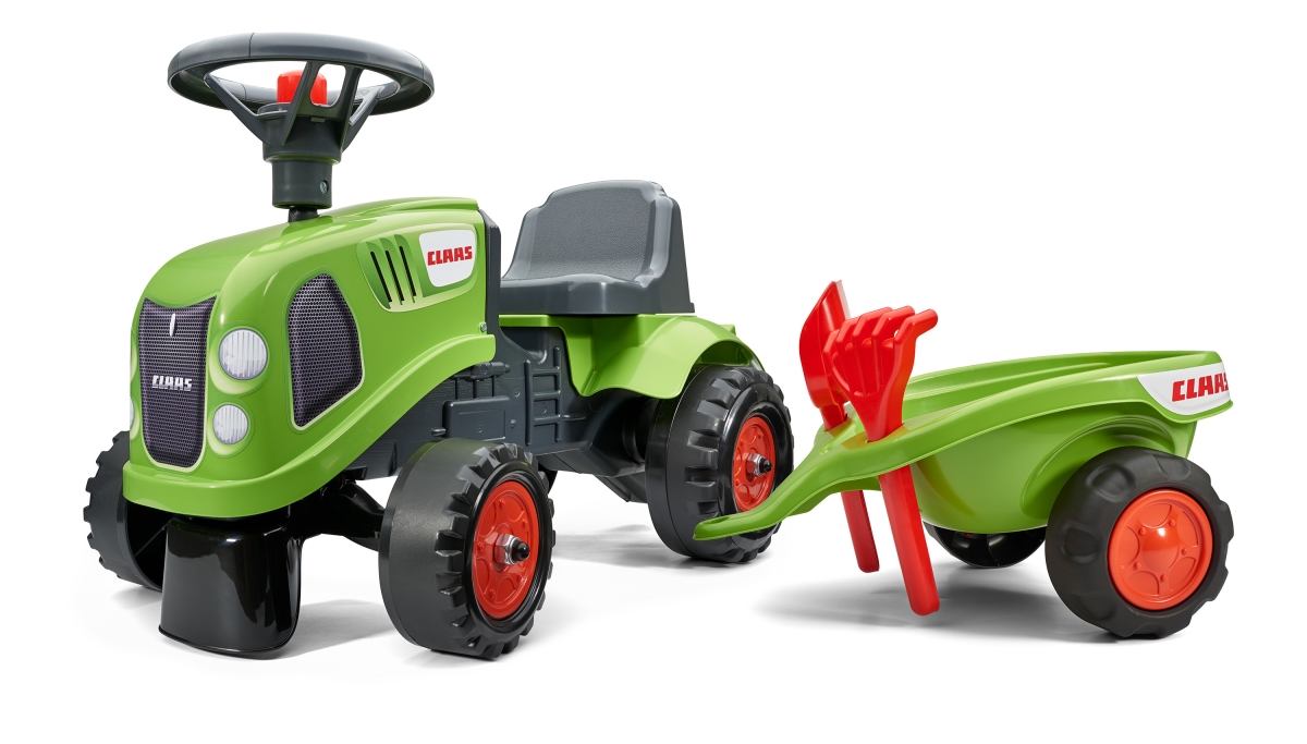 Green plastic ride-on tractor with a black steering wheel, red wheels, and a matching green trailer featuring a red handle, designed for children.