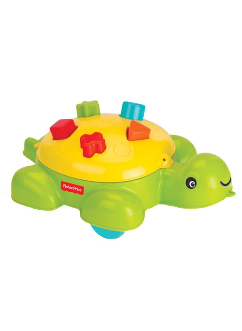Bright green turtle shape sorter with a yellow shell, featuring colorful geometric blocks and a smiling face, made of durable plastic for toddlers.