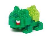 Green and yellow Nanoblock model of Bulbasaur, featuring a blocky design with distinct eyes and a red and white detail on its face, made of plastic.