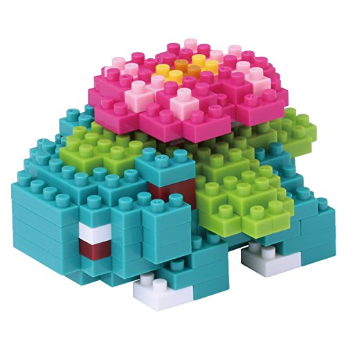 Colorful Nanoblock Venusaur model featuring a green body, pink flower on top, and detailed leaf structures, made of small interlocking plastic blocks.