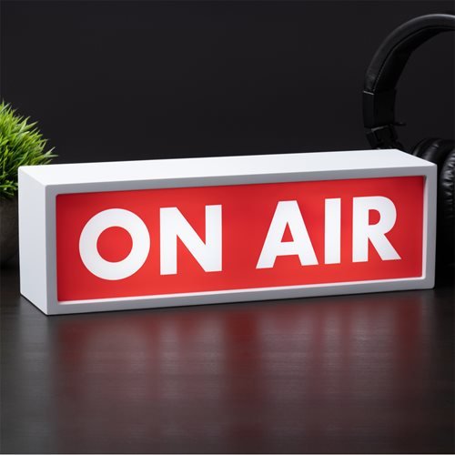 A rectangular white light box features bold white letters spelling "ON AIR" against a vibrant red background, perfect for signaling broadcasting status.