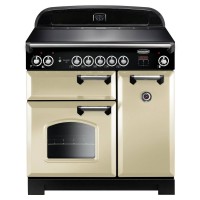 Classic 90cm induction range cooker in cream with chrome trim, featuring a black top, multiple control knobs, and two ovens with a glass window.