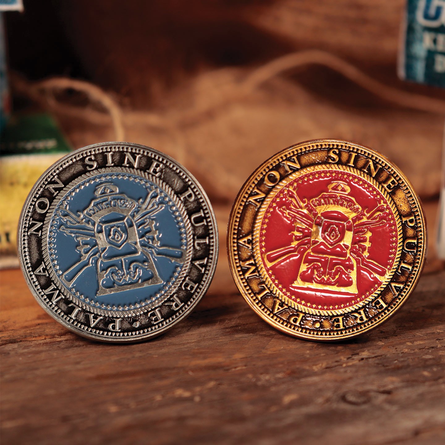 Set of two collectible tokens from Resident Evil 4, featuring a blue token with a crown design and a red token with a gold border, both made of metal with intricate detailing.