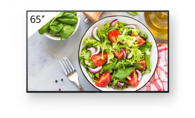 65-inch Sony FW-65BZ35L digital signage display featuring vibrant colors, a sleek black frame, and a clear image of a fresh salad with greens and tomatoes.