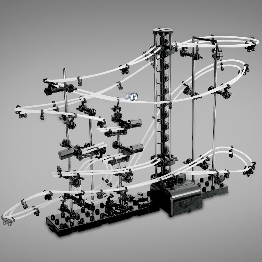 A black and silver marble coaster game featuring intricate transparent tracks, multiple loops, and a central vertical tower for marbles to navigate through.
