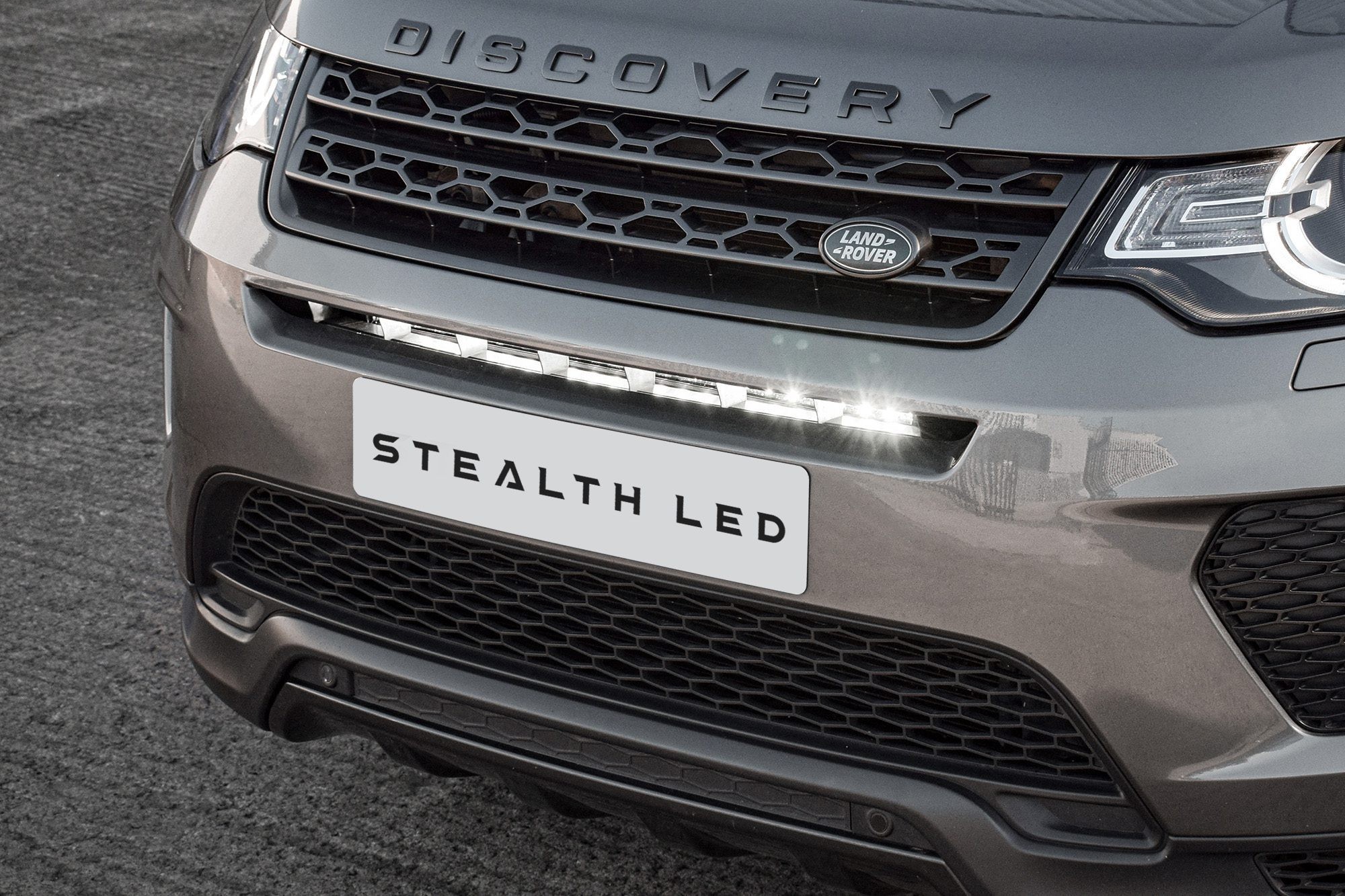 Luminous LED integration grille kit for Land Rover Discovery Sport 2014-2019, featuring a sleek black design with bright white LEDs, enhancing visibility and style.
