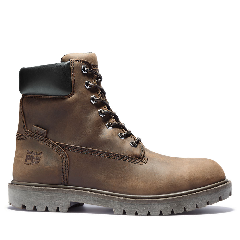 Brown leather Timberland Pro safety boots featuring metal eyelets, black padded collar, and rugged rubber sole for enhanced grip and durability.