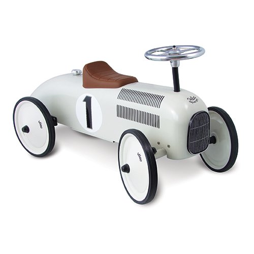 Vintage-style ride-on racing car in white and cream, featuring a brown leather seat, a shiny silver steering wheel, and black wheels with white rims, marked with the number "1."